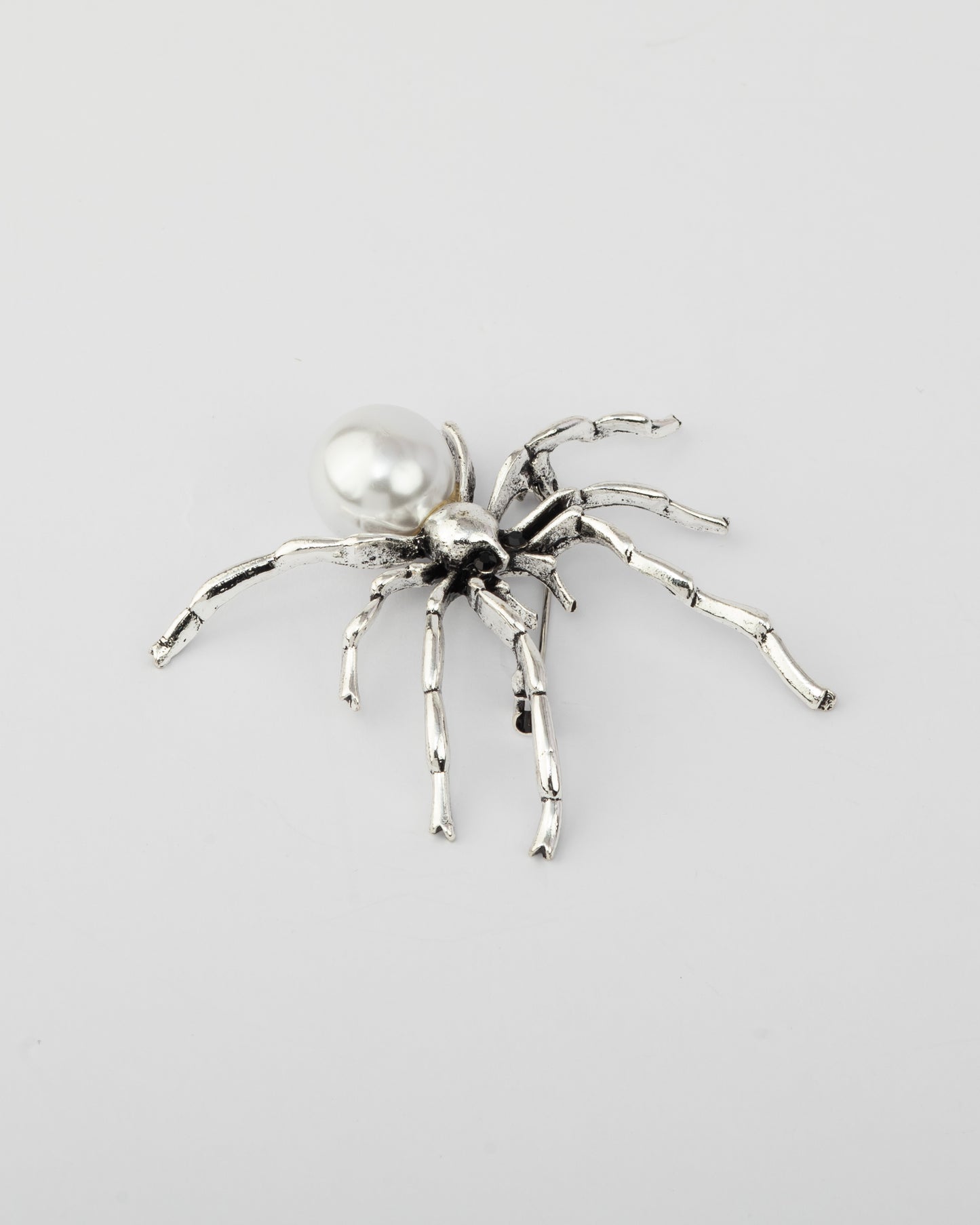 The silver spinner brooch