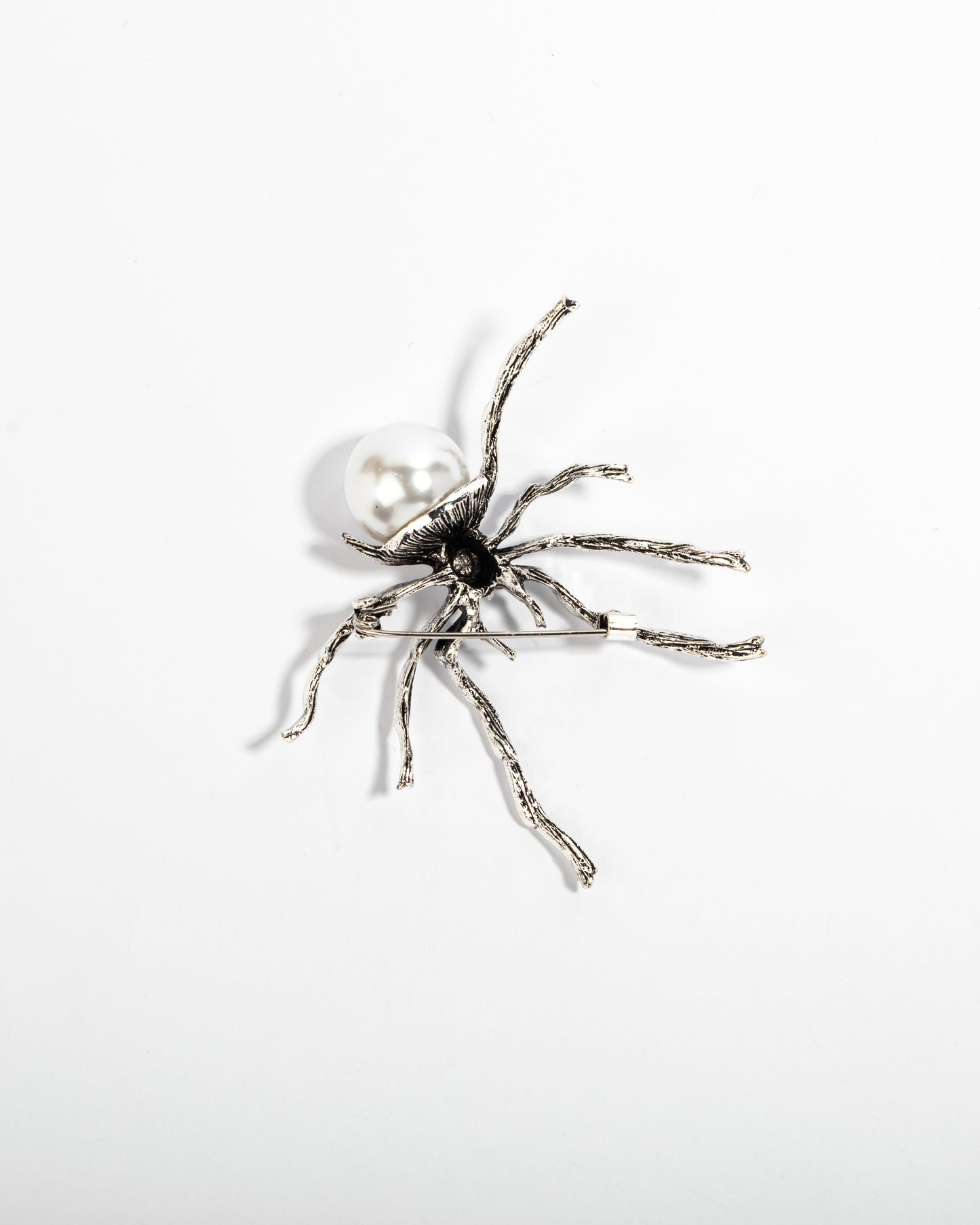 The silver spinner brooch