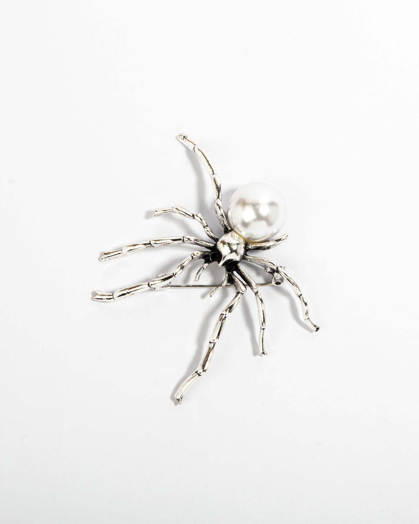 The silver spinner brooch